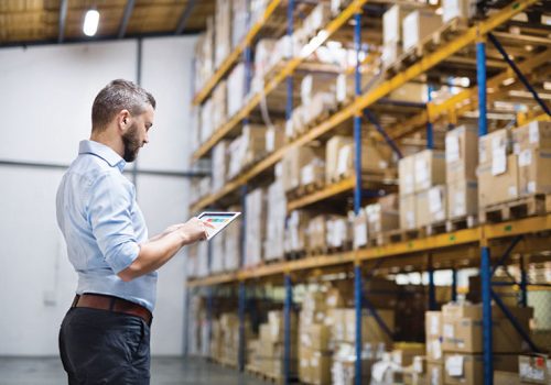 Man warehouse worker with a tablet. Handsome man warehouse worker with a tablet.